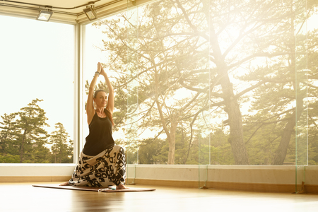 A yoga master practicing yoga performing Virabhadrasana poseの写真素材
