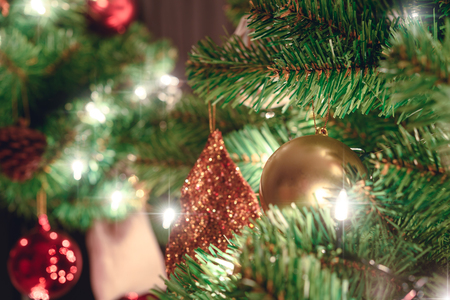 Close up christmas tree decorated with santa claus doll and christmas balls and lightの写真素材