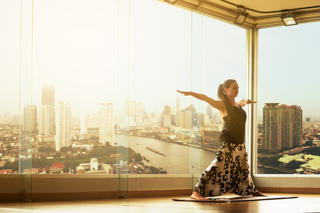 A yoga master practicing yoga performing a stand poseの写真素材
