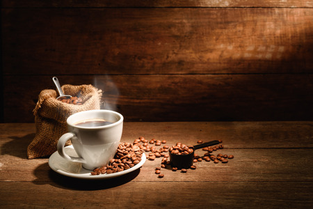 A cup of black coffee or americano with roasted coffee bean in bag, good coffee for health is black coffee without sugar and milkの写真素材