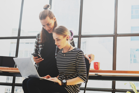 Two freelance working in coffee shop, Nomad worker conceptual, couple work together in cafe with laptop and smartphoneの写真素材