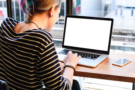 freelance working in coffee shop, Nomad worker conceptual, white blank laptop screen
