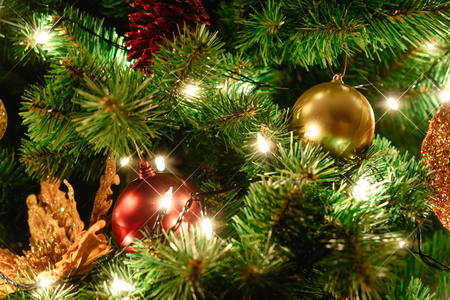 Close up christmas tree decorated with christmas balls and lightの写真素材