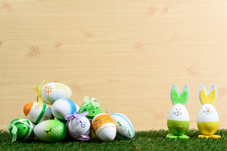 Easter decorative background on grass and wooden floorの写真素材