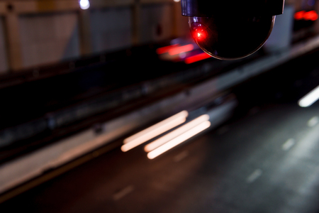 CCTV surveillance camera operating on super high way road in tunnel at nightの写真素材