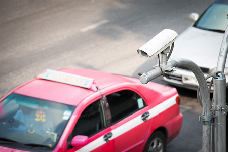 CCTV surveillance camera operating on traffic roadの写真素材