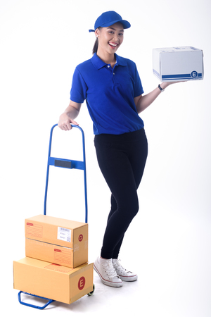 Beautiful young woman in blue uniform of delivery service, online shopping delivery conceptの写真素材