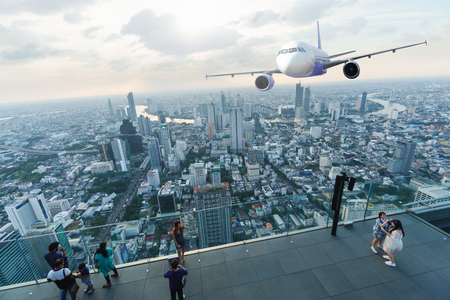 Scene of airplane over city with sun light and light ray over city of Bangkokのeditorial素材