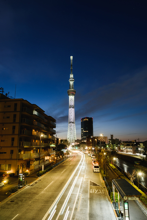 Tokyo sky tree, the tallest building in Japan with light of car run on street at sunsetのeditorial素材