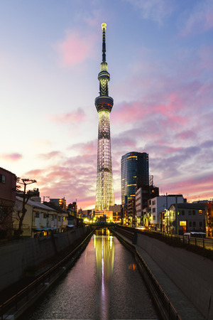 Tokyo sky tree, the tallest building in Japan with light of car run on street and reflection in water from canal at sunsetのeditorial素材