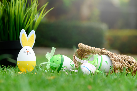 Decorative eggs on green grass for Easter celebrationの写真素材