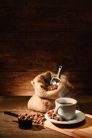 Vertical of a shot of espresso with roasted coffee beanの写真素材