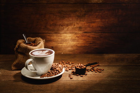 A cup of latte art with roasted coffee bean in bagの写真素材