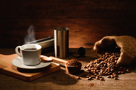 A shot of espresso with roasted coffee bean and alumenium coffee grinderの写真素材