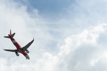 BANGKOK, THAILAND- 24 October 2018 : Ant eye view of Airasia take off on sky position in bottom left cornerのeditorial素材