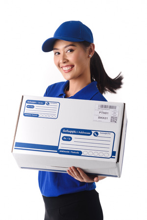 Beautiful young woman in blue uniform of delivery service, online shopping delivery conceptの写真素材