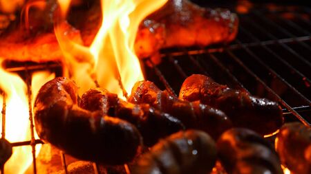 Flame roast sausage on barbecue stoveの写真素材