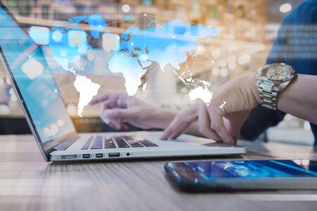 Globalization conceptual of technology use laptop and smartphone, wireless internet connection every whereの写真素材