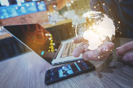 Globalization conceptual of technology use laptop and smartphone, wireless internet connection every whereの写真素材