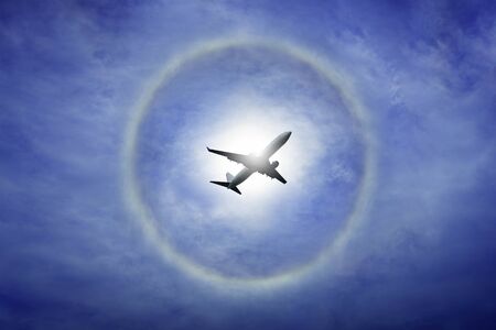 sun halo on blue sky and cloud, circle ring of rainbow around the sun, natural phenomenon from moisture in the airの写真素材