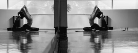 Young asian woman perform yoga training with very flexible body in black and white toneの写真素材