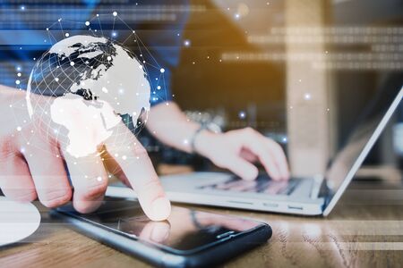 Globalization conceptual of technology use laptop and smartphone, wireless internet connection everywhereの写真素材