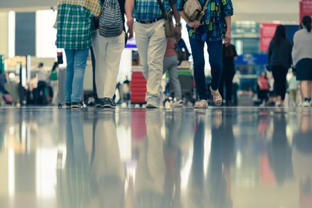 Scene of traveller with luggage reflection on floor in airport during busy hourの写真素材