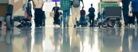 Scene of traveller with luggage reflection on floor in airport during busy hour