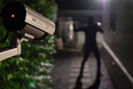 CCTV surveillance camera operate during night capture thief while break into a houseの写真素材