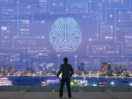 businessman stand on roof top of skyscrabber with AI conceptual itemの写真素材
