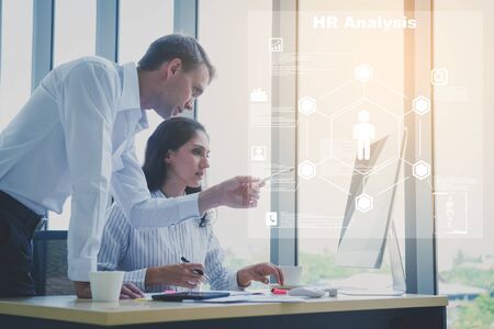 Two business person working on HR Analysis programの写真素材