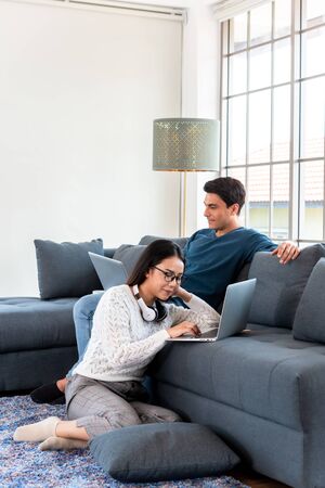 Couple work at home during lock down of corona virus outbreak use laptop connected to internet on concept of working at homeの写真素材