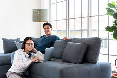 Couple work at home during lock down of corona virus outbreak use laptop connected to internet on concept of working at homeの写真素材