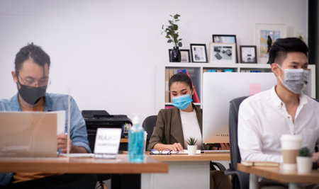 Asian businesswoman wearing mask in office show new normal office lifestyleの写真素材