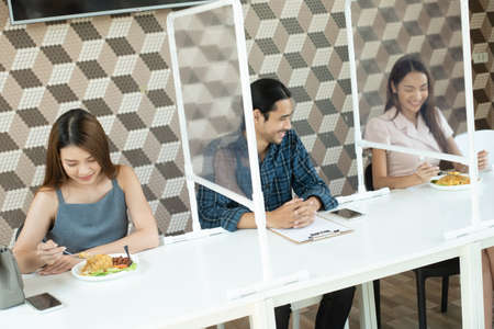 Group of friends three person meet in restaurant with new normal life styleの写真素材