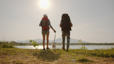 Couple backpacker and their dog on backpacking trip reach destination