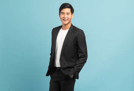 Good looking businessman portrait isolated on blue backgroundの写真素材