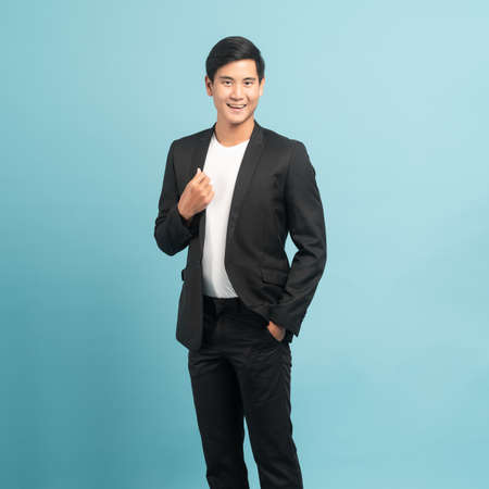 Good looking businessman portrait isolated on blue backgroundの写真素材