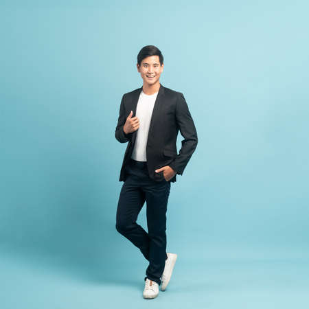 Good looking businessman portrait isolated on blue backgroundの写真素材