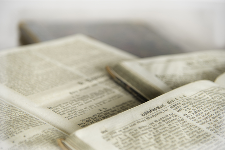 Some old text in a open book laying on the tableの写真素材