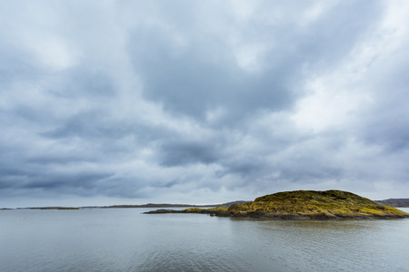 Cloudy sky with an island in foregroundの写真素材