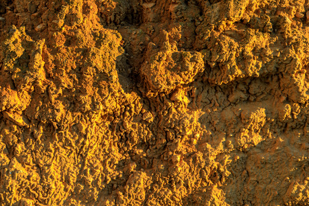 Wall of adobe, earth, mud, straw, pressed. Old, traditional and sustainable construction. Eroded by...