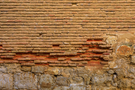 Wall of old, deteriorated bricks and stones, red, reddishの写真素材