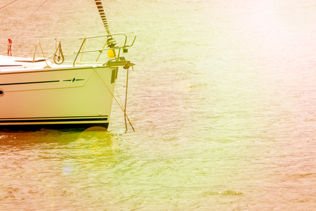 Sport sail boat bow docked in bay on a very sunny day. Space to insert your text here.