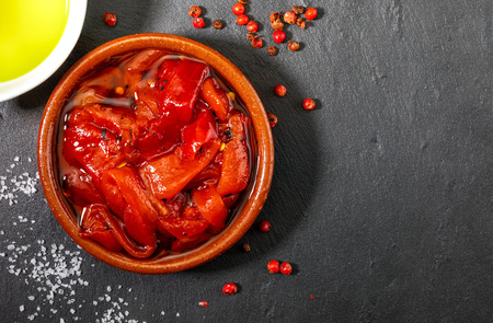 Delicious and appetizing red peppers roasted at home. Extra virgin olive oil, salt and pepper. On...