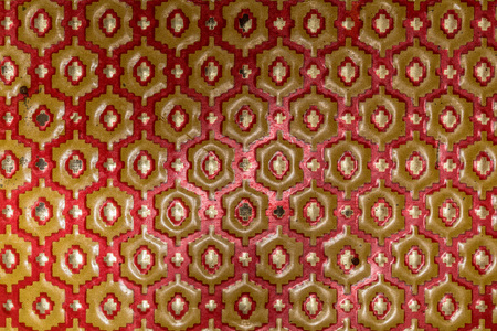 Metallic texture of red and yellow hexagons. Pattern. Retro look, old and shiny.