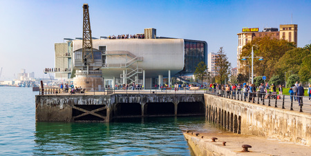 SANTANDER, SPAIN - October 21, 2018. Maritime walk of Santander (Cantabria) on a sunny day. People walking Side view of the Stone Crane and the Boton Center (designed by the architect Renzo Piano.) The Hotel Bah?a (4 stars) can also be seen.のeditorial素材