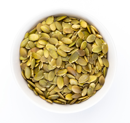 Pumpkin seeds (peeled seeds) in white bowl (Various nuts collection). Isolated on white background.の写真素材