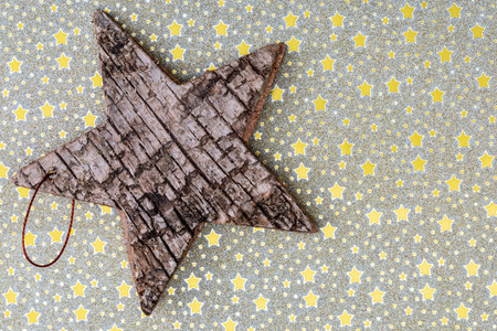 Beautiful star of birch bark on golden stars background. Ready for Christmas greeting.の写真素材