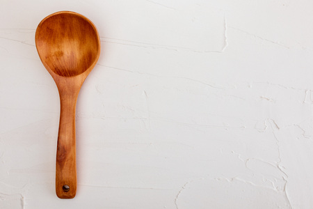 Wooden spoon on white background with texture. Space to insert your text here. Letter for restaurants. (Food concept of spoon, pot).の写真素材